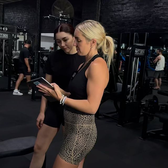 Evolve personal trainer Bree showing a client her training data on an ipad